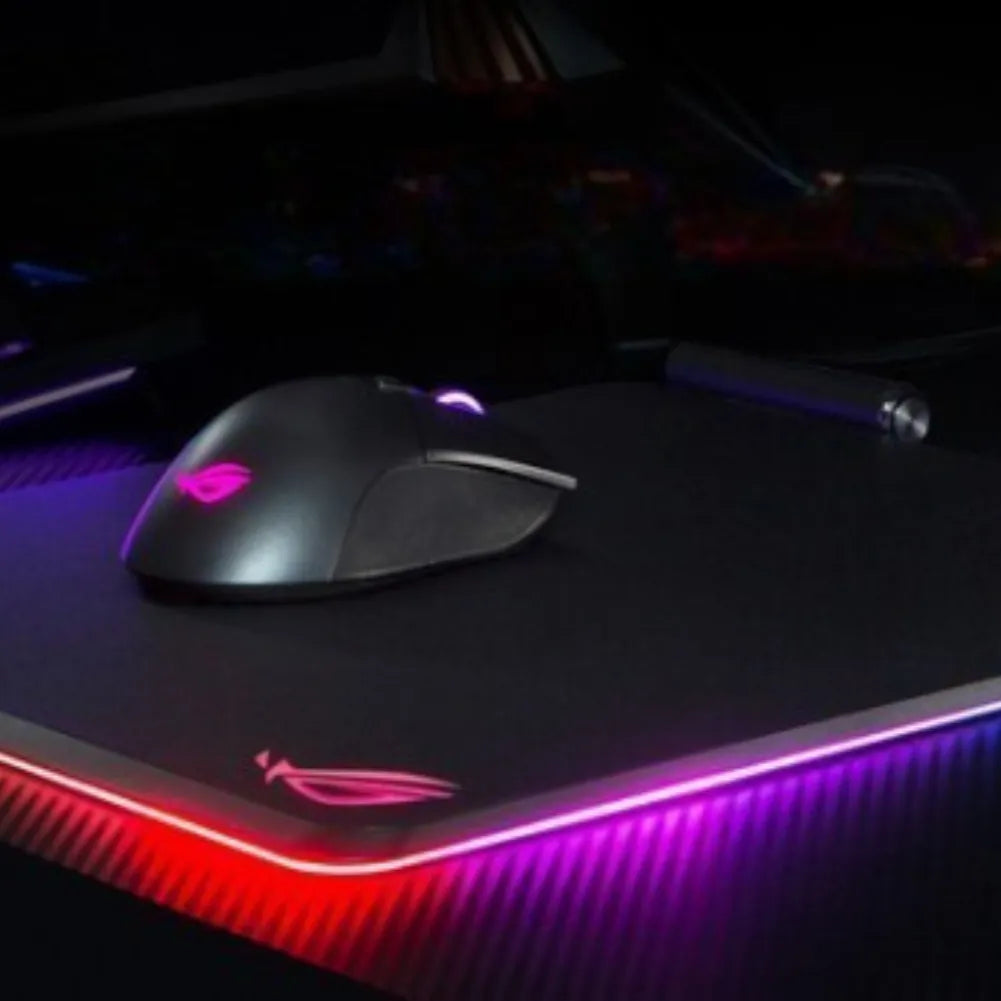ROG Balteus Qi gaming mouse pad with RGB lighting and gaming mouse on a sleek surface.