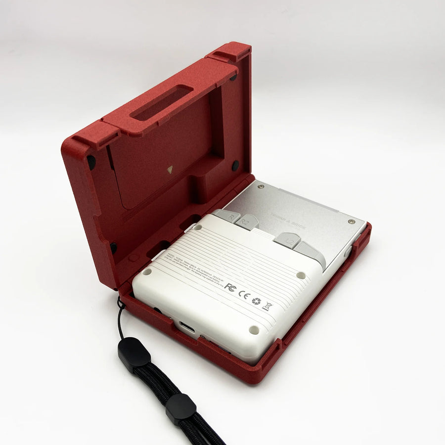 Red 3-in-1 case for TrimUI Brick used as a display stand