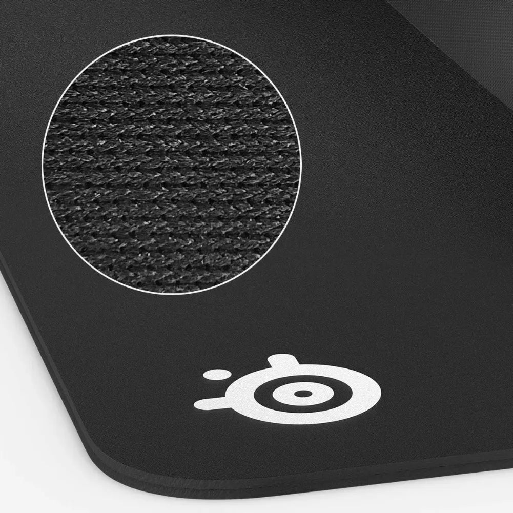 Zoom on the textured surface of the SteelSeries QcK Heavy XXL gaming mouse pad, showcasing its fabric quality.