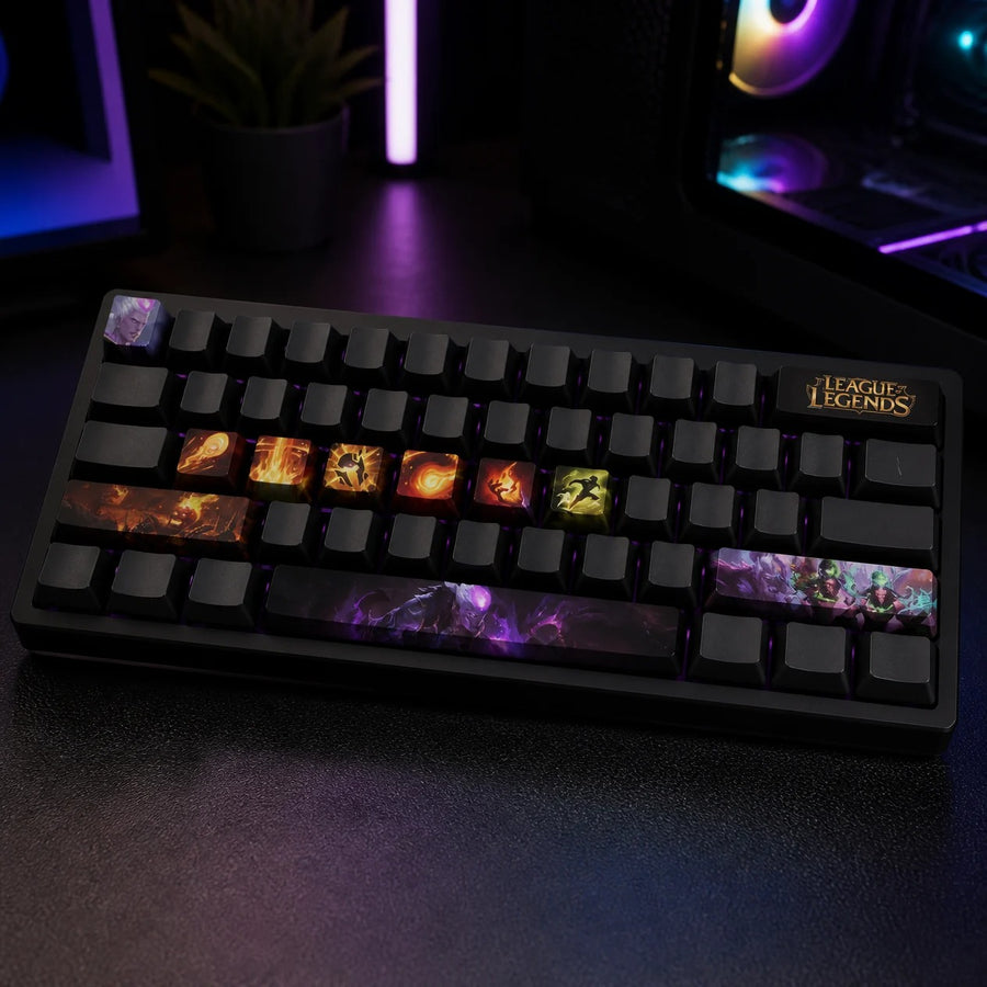 Brand keycaps fitted on a black mechanical keyboard in front of a gaming PC
