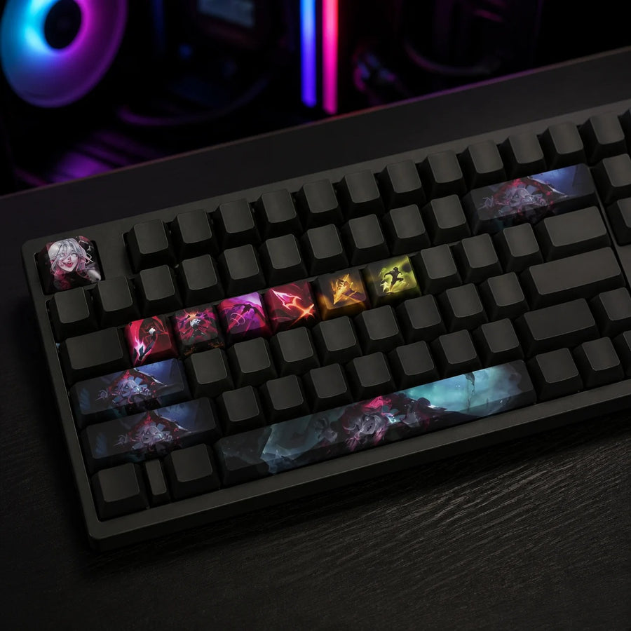 Briar keycaps fitted on a black mechanical keyboard in front of a gaming PC