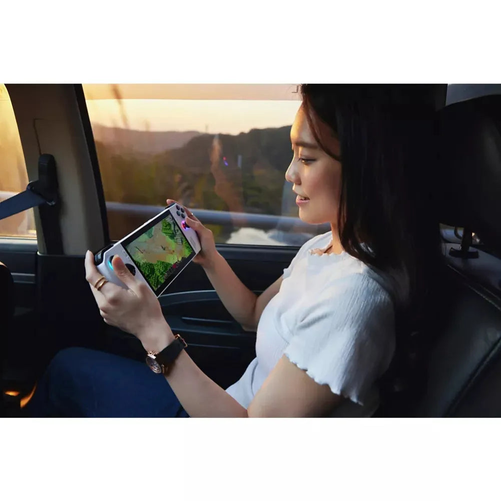 Woman enjoying gaming on Asus ROG Ally portable console in a car during sunset.