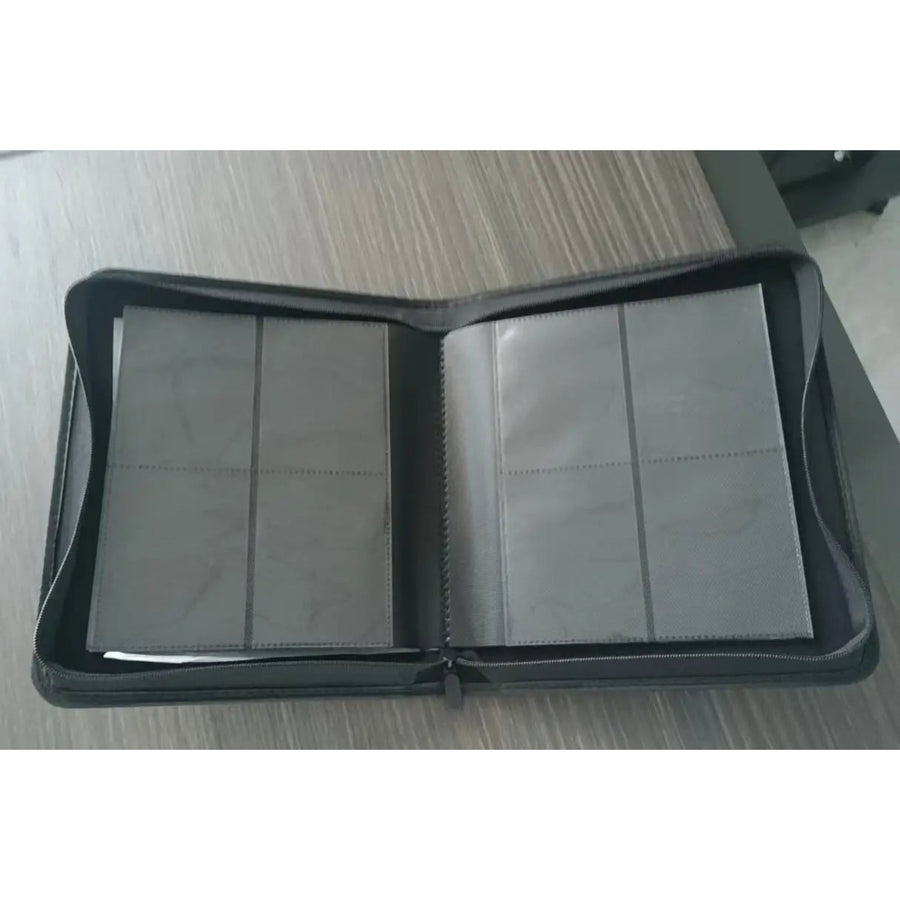 Homefish binder open on a double page of 4 toploader-size pockets