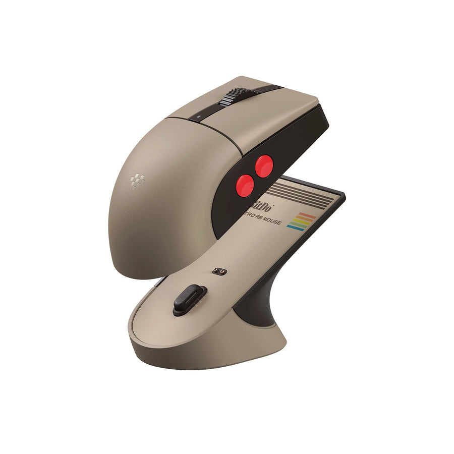 8BitDo Retro R8 C64 Edition mouse in beige and brown resting on its charging dock
