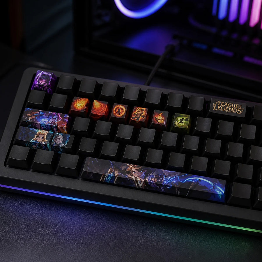Annie keycaps fitted on a black mechanical keyboard in front of a gaming PC